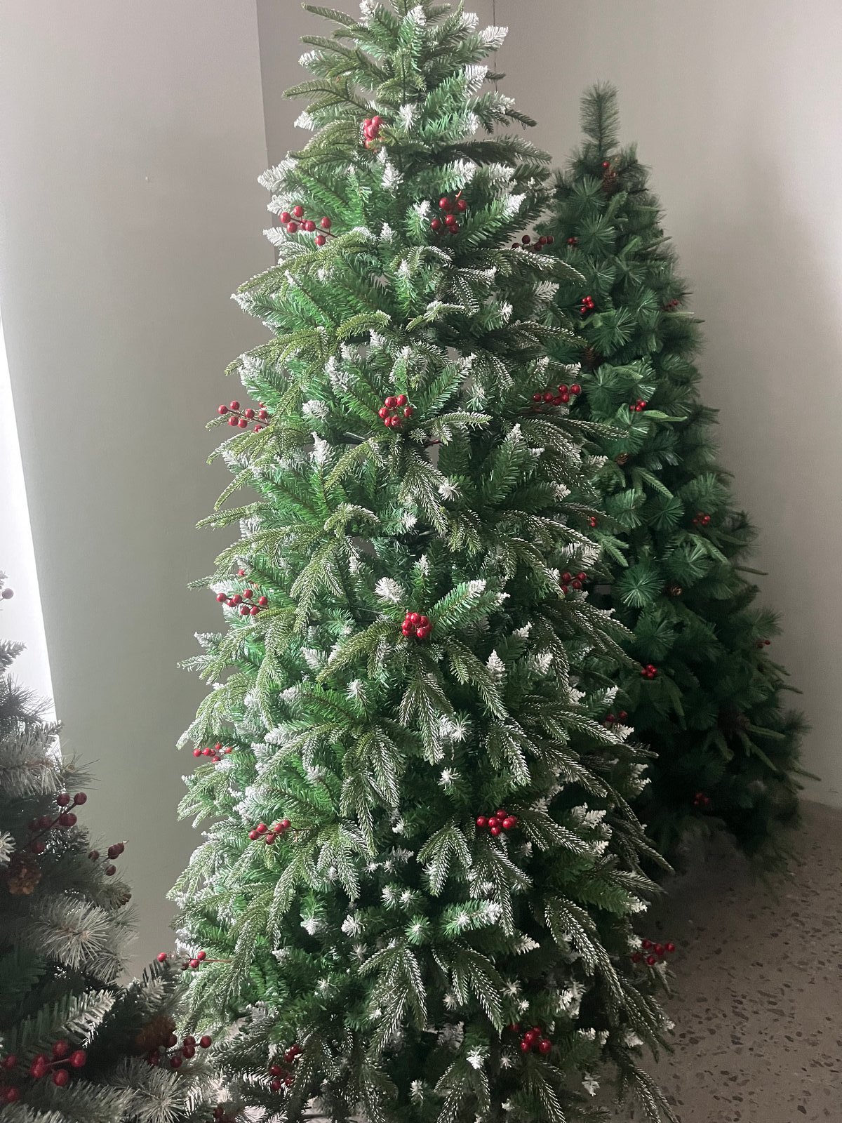 Flocked artificial Christmas tree with red berries